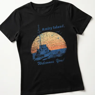 Retro distressed t-shirt featuring a vintage fishing boat and welcoming text — printed on a women's shirt