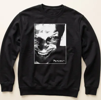 Black and white abstract graphic of Aphex Twin face with printed text. — printed on a unisex sweatshirt