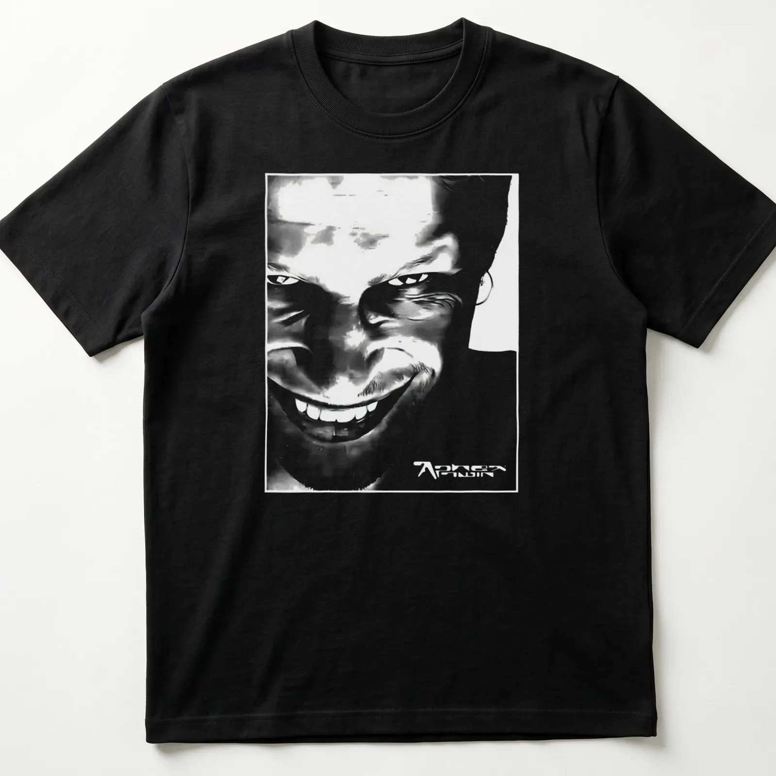 Black and white abstract graphic of Aphex Twin face with printed text. — printed on a unisex t-shirt