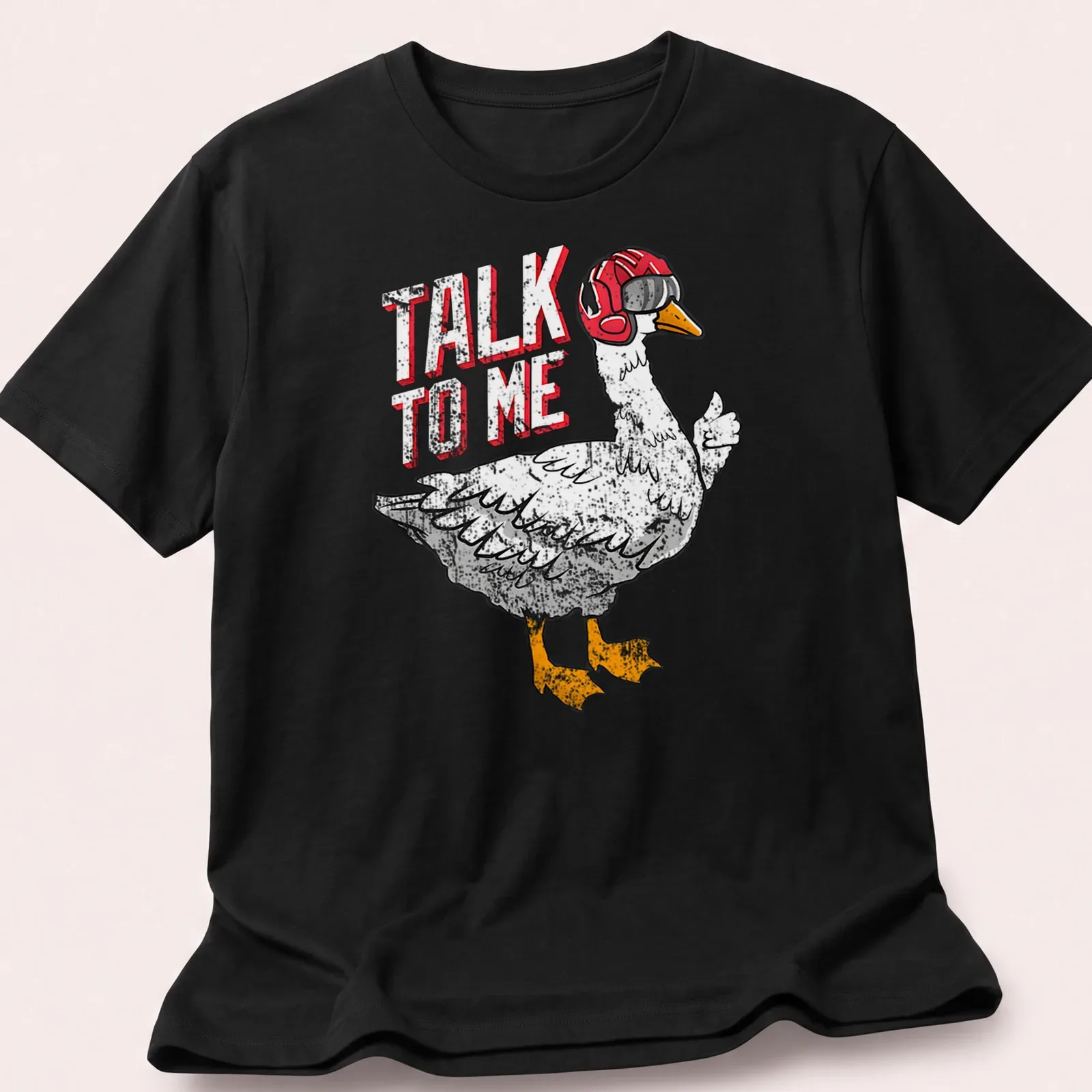 Cartoonish aviator goose with goggles and the text 'TALK TO ME' — printed on a unisex t-shirt