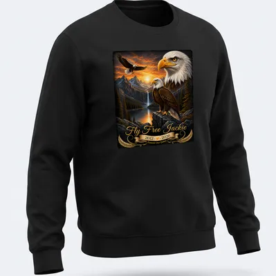 Realistic bald eagle soaring with tribute text for Jackie, featuring gold and brown tones. — printed on a unisex sweatshirt