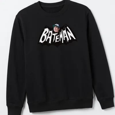 Bold Bateman text in black and white on a graphic — printed on a unisex sweatshirt