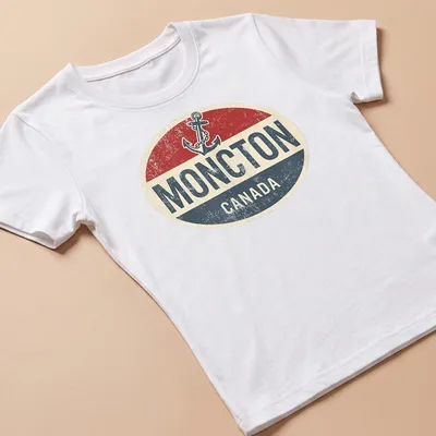 Retro vintage shirt featuring a boat anchor and Moncton Canada text in bold colors — printed on a women's shirt