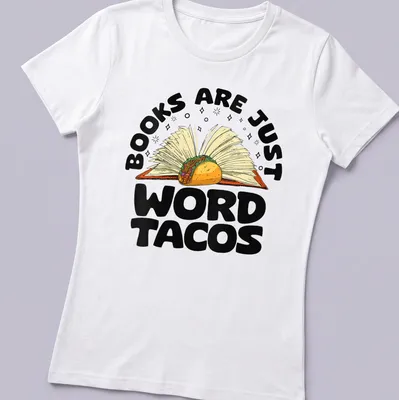 Colorful cartoon of an open book holding a taco with humorous text — printed on a women's shirt