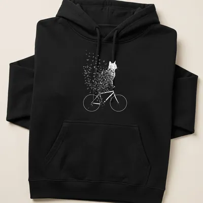 Whimsical line-art of a cat on a bicycle surrounded by butterflies in black and white — printed on a unisex hoodie