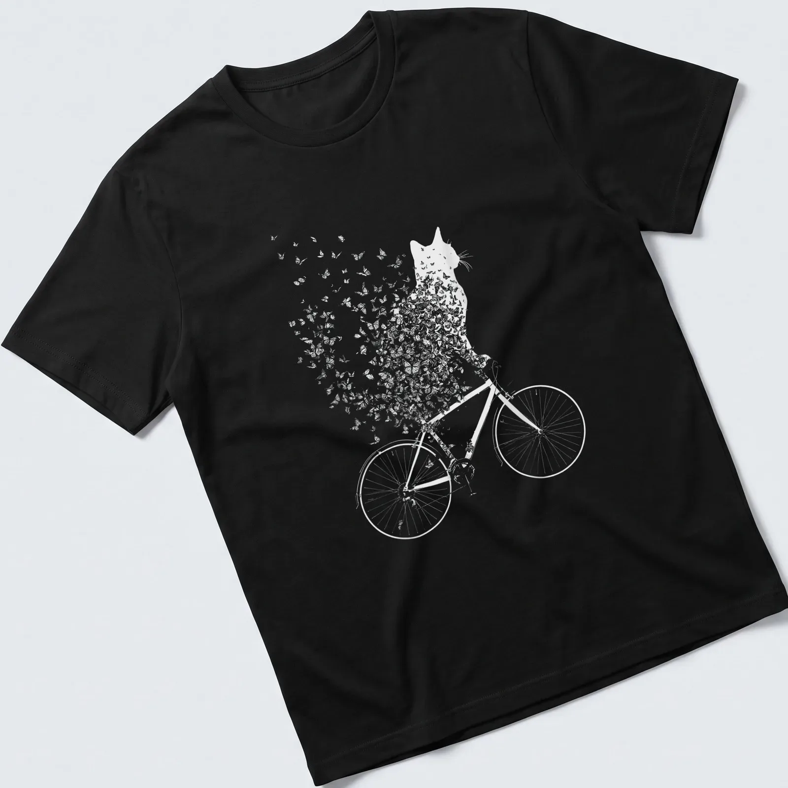 Whimsical line-art of a cat on a bicycle surrounded by butterflies in black and white — printed on a unisex t-shirt