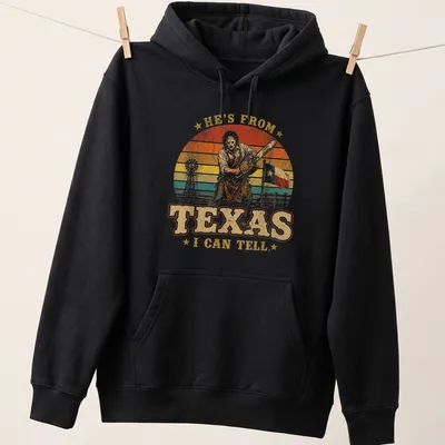 Vintage retro T-shirt featuring a chainsaw killer with bold text above — printed on a unisex hoodie