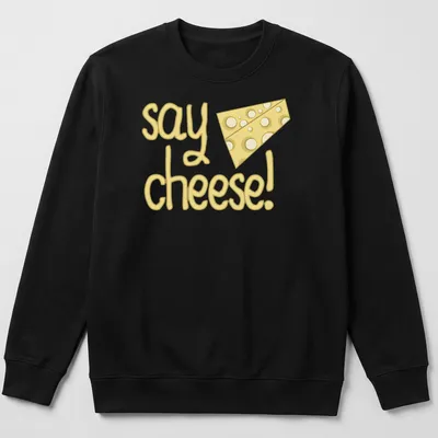 Playful cartoon cheese with text 'say cheese!' in yellow tones — printed on a unisex sweatshirt