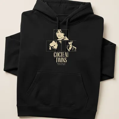 Minimalist Cocteau Twins t-shirt with white text on a cream background — printed on a unisex hoodie