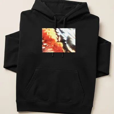 Abstract coral bloom graphic in orange, black, and white colors — printed on a unisex hoodie