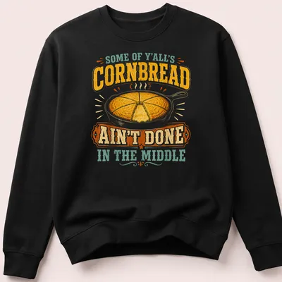 Vintage rustic T-shirt featuring cornbread in a skillet with humorous text about cooking. — printed on a unisex sweatshirt