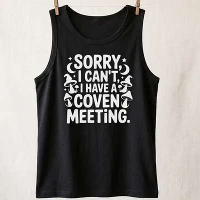 Playful graphic featuring the text 'Sorry I Can’t I Have A Coven Meeting' in black, white, and purple — printed on a tank top