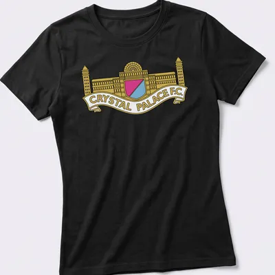 Bold graphic Crystal Palace F.C. crest logo in gold, pink, light blue, and white — printed on a women's shirt