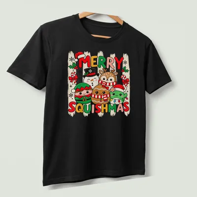 Kawaii style t-shirt featuring cute holiday characters and Merry Squishmas text — printed on a unisex t-shirt (angled view)
