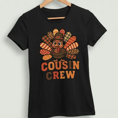 Cartoon turkey design with 'Cousin Crew' text, bright colors for Thanksgiving. — printed on a women's shirt