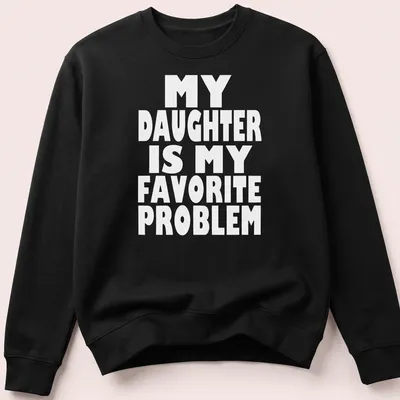 Bold typography t-shirt with the phrase 'MY DAUGHTER IS MY FAVORITE PROBLEM' in white. — printed on a unisex sweatshirt