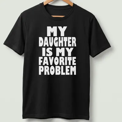 Bold typography t-shirt with the phrase 'MY DAUGHTER IS MY FAVORITE PROBLEM' in white.