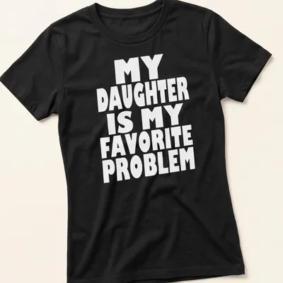 Bold typography t-shirt with the phrase 'MY DAUGHTER IS MY FAVORITE PROBLEM' in white. — printed on a women's shirt