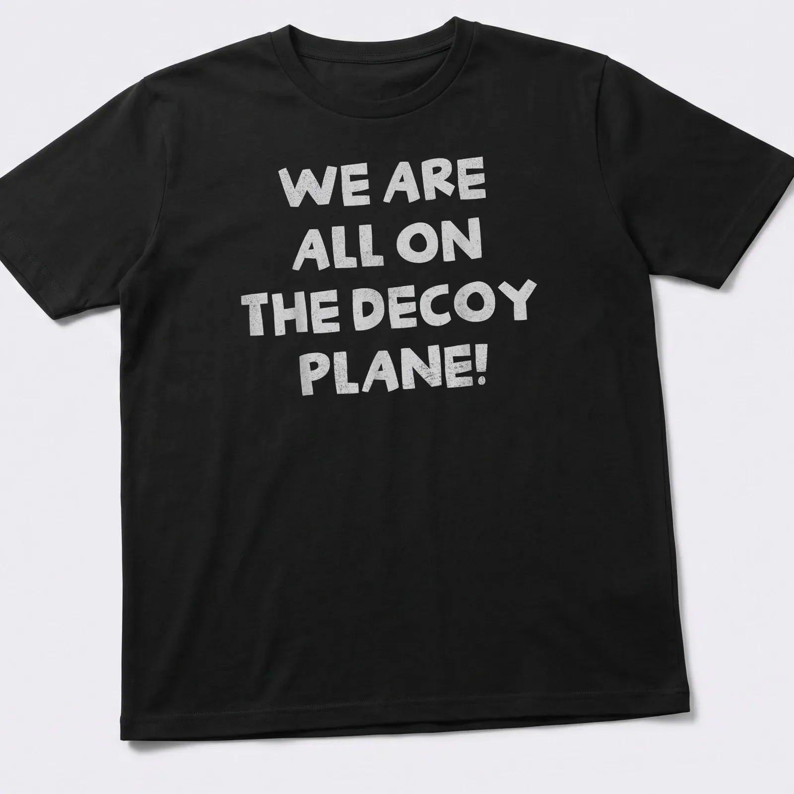 Playful typography t-shirt with the phrase 'We Are All On The Decoy Plane!' — printed on a unisex t-shirt