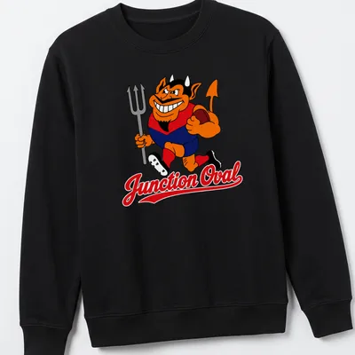 Cartoon Demons character running with a football and Junction Oval text — printed on a unisex sweatshirt