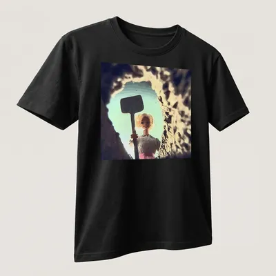 Distressed T-shirt featuring a whimsical doll face design in light blue and pink. — printed on a unisex t-shirt (angled view)