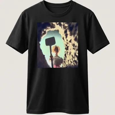 Distressed T-shirt featuring a whimsical doll face design in light blue and pink.
