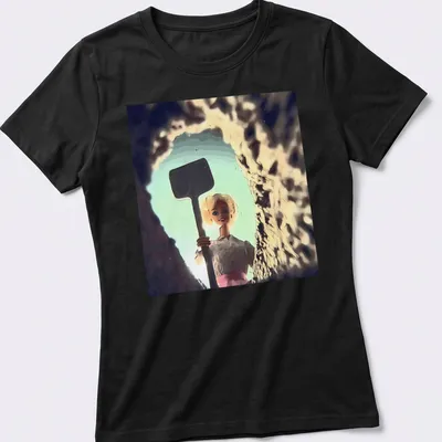 Distressed T-shirt featuring a whimsical doll face design in light blue and pink. — printed on a women's shirt