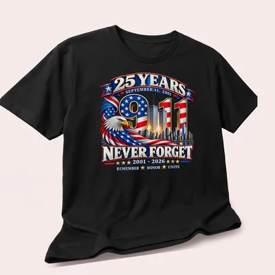 Patriotic eagle design honoring 9/11 with skyline and text — printed on a unisex t-shirt (angled view)