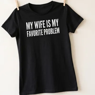 Distressed humorous slogan on a black tee: My Wife Is My Favorite Problem — printed on a women's shirt