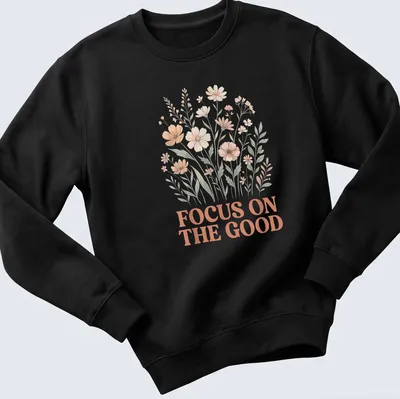 Floral line-art T-shirt featuring the phrase Focus On The Good above wildflowers — printed on a unisex sweatshirt