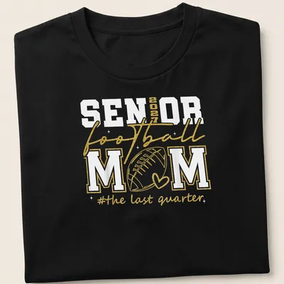 Glittery shirt featuring text celebrating a senior football mom in gold and white.