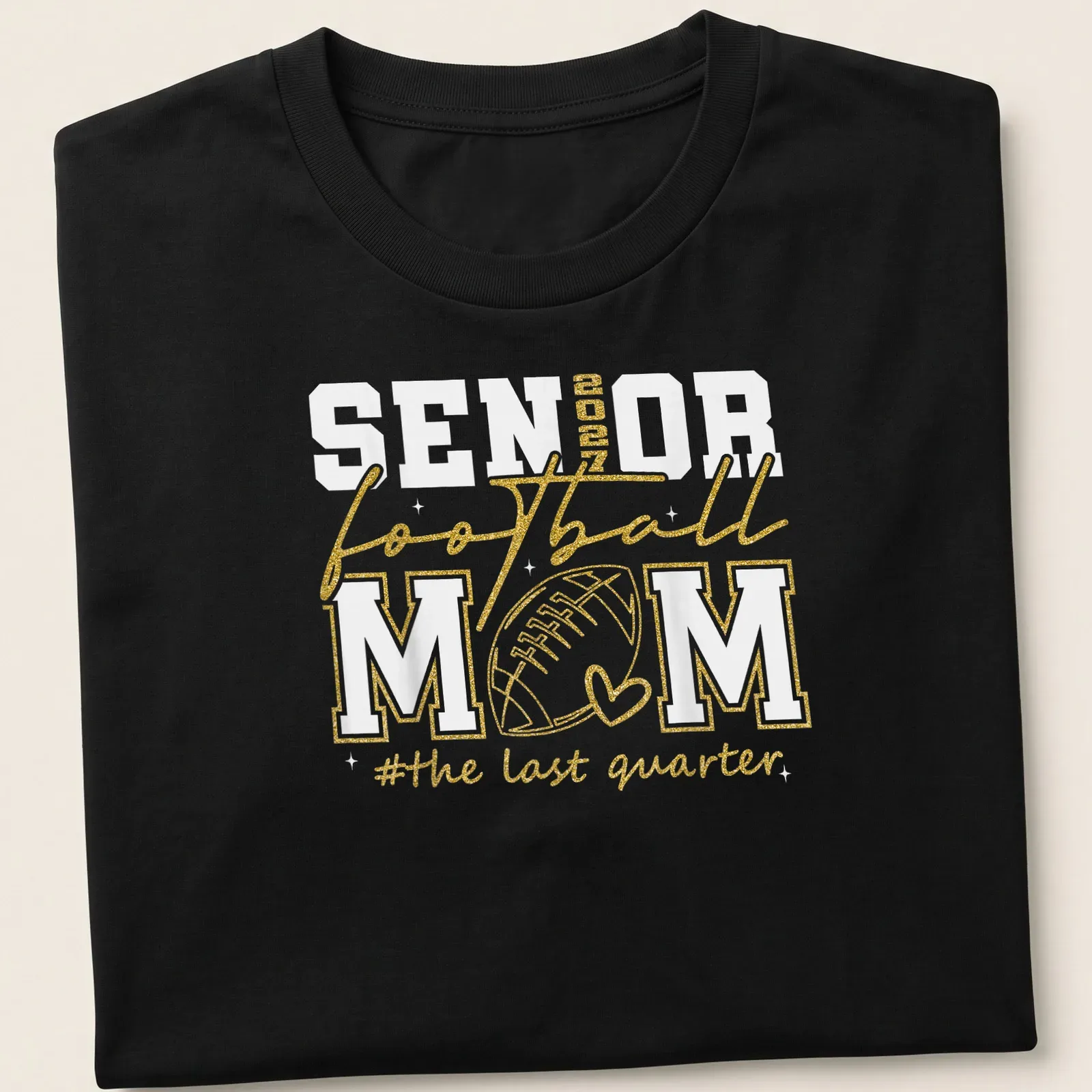 Glittery shirt featuring text celebrating a senior football mom in gold and white. — printed on a unisex t-shirt