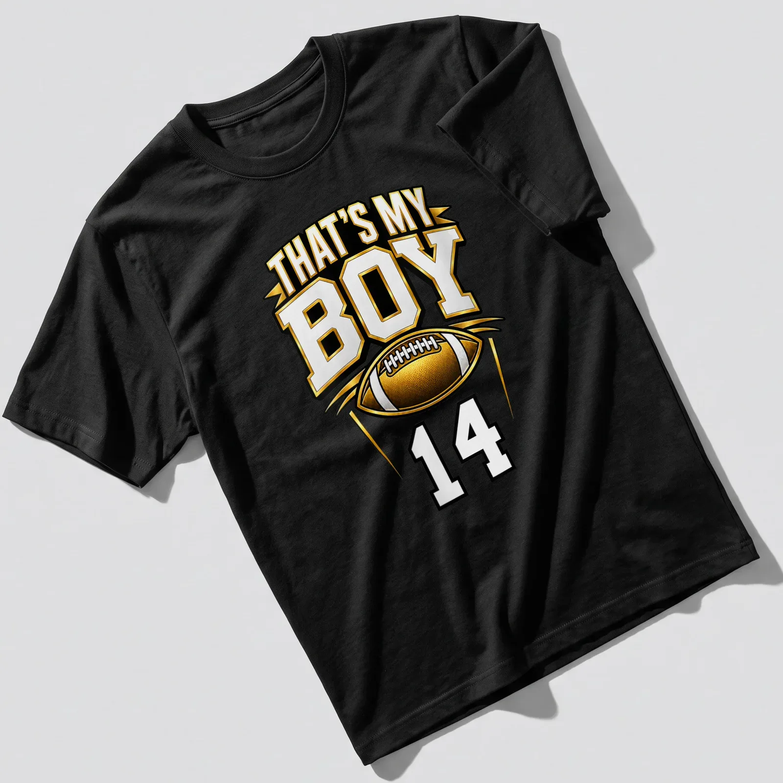 Bold typography t-shirt with text 'That's My Boy 14' in gold, black, and white — printed on a unisex t-shirt