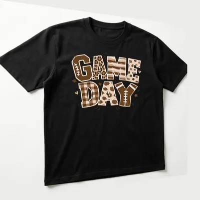Retro football-themed t-shirt with bold 'Game Day' lettering and colors of brown and cream — printed on a unisex t-shirt (angled view)