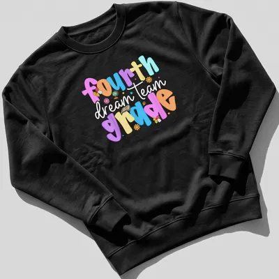 Colorful playful design featuring 'fourth grade dream team' text in bright colors — printed on a unisex sweatshirt
