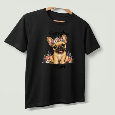 Illustration of a French Bulldog with a floral crown and text saying 'Frenchie Mom' — printed on a unisex t-shirt (angled view)