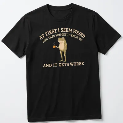 Whimsical illustration of a frog holding a coffee mug with funny text — printed on a unisex t-shirt