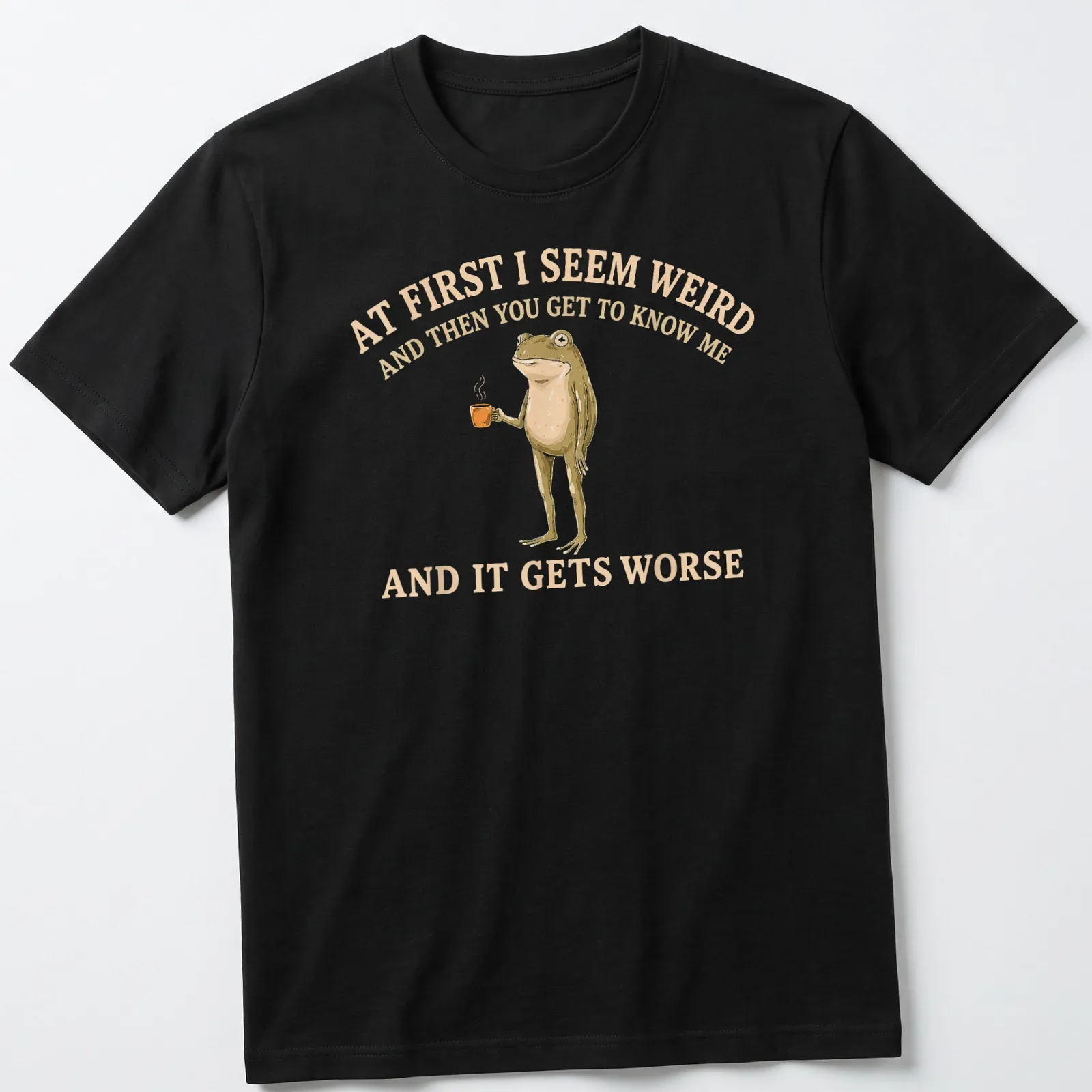 Whimsical illustration of a frog holding a coffee mug with funny text — printed on a unisex t-shirt