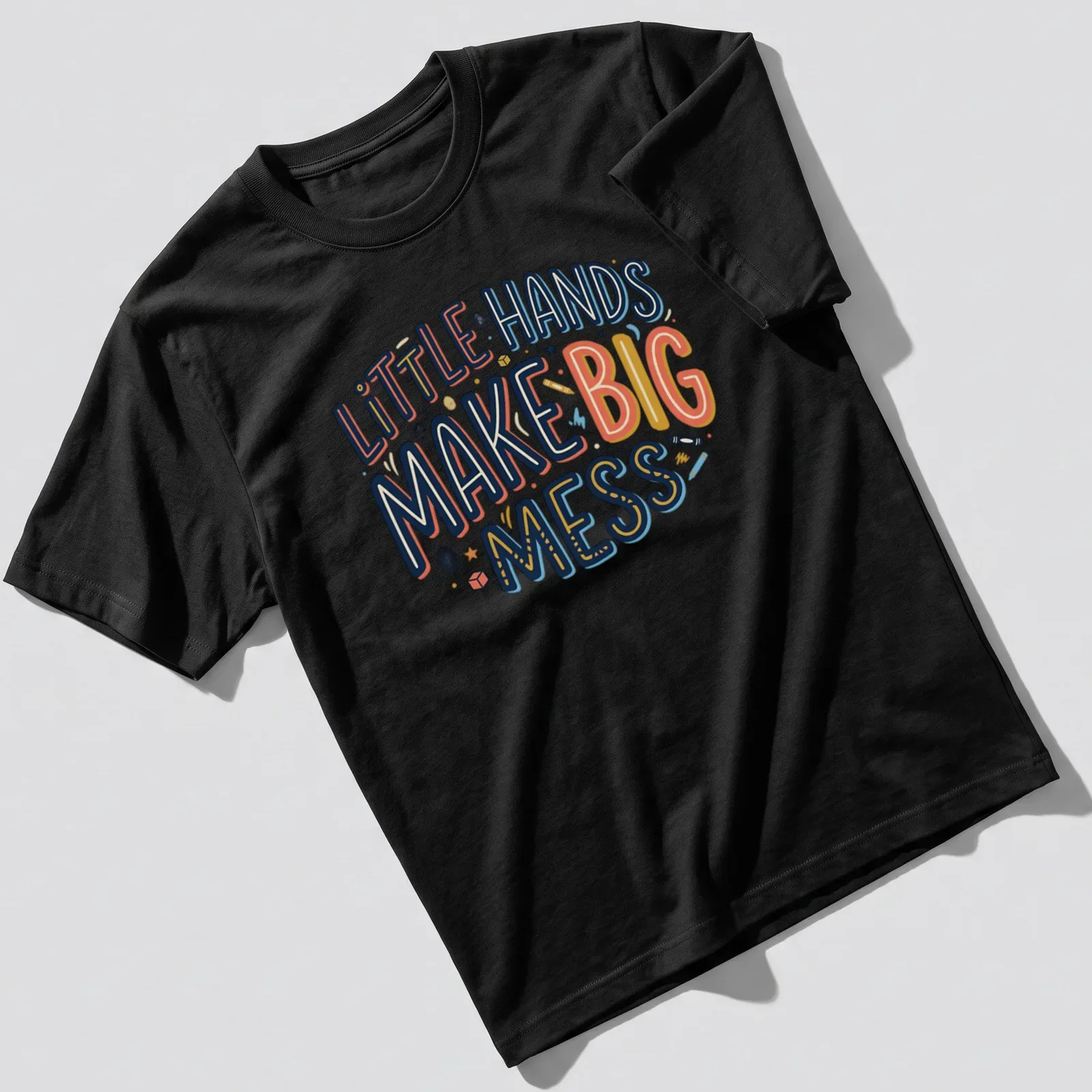 Playful typography shirt with text 'Little Hands Make Big Mess' in bright colors. — printed on a unisex t-shirt
