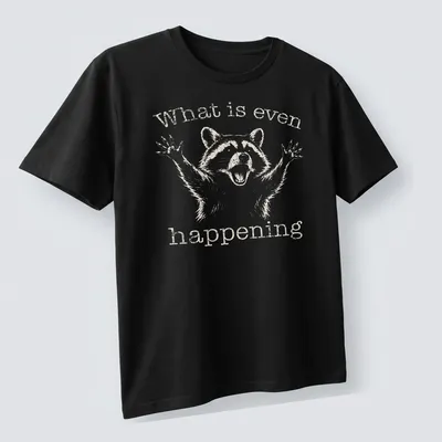 Vintage distressed Funny Raccoon t-shirt with the text 'What is even happening' — printed on a unisex t-shirt (angled view)