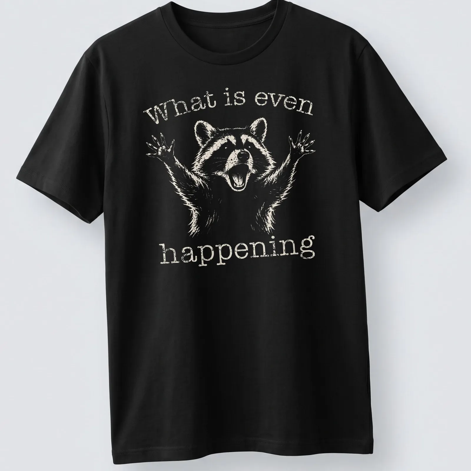 Vintage distressed Funny Raccoon t-shirt with the text 'What is even happening' — printed on a unisex t-shirt