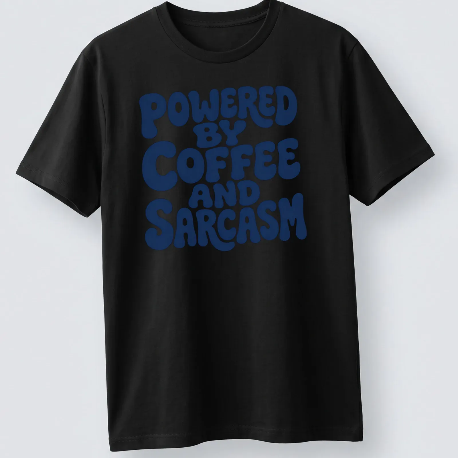 Bold typography shirt with the quote 'Powered By Coffee And Sarcasm' in navy and white — printed on a unisex t-shirt