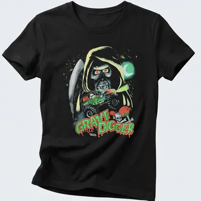 Halloween-themed Grave Digger monster truck graphic in green, red, black, and white — printed on a women's shirt