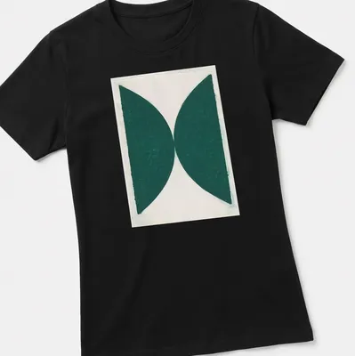 Minimalist t-shirt featuring green abstract shapes on a white background — printed on a women's shirt