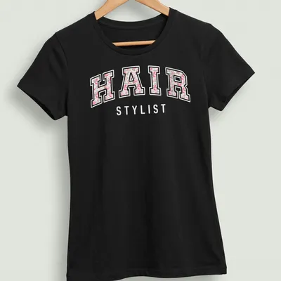 Cute retro floral design with 'HAIR STYLIST' text and pink flowers — printed on a women's shirt