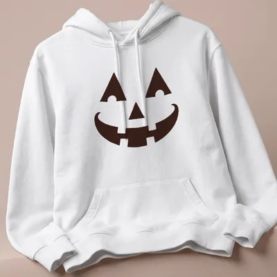 Simple graphic of a happy pumpkin face on a black t-shirt for Halloween — printed on a unisex hoodie