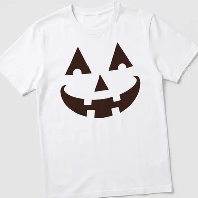 Simple graphic of a happy pumpkin face on a black t-shirt for Halloween