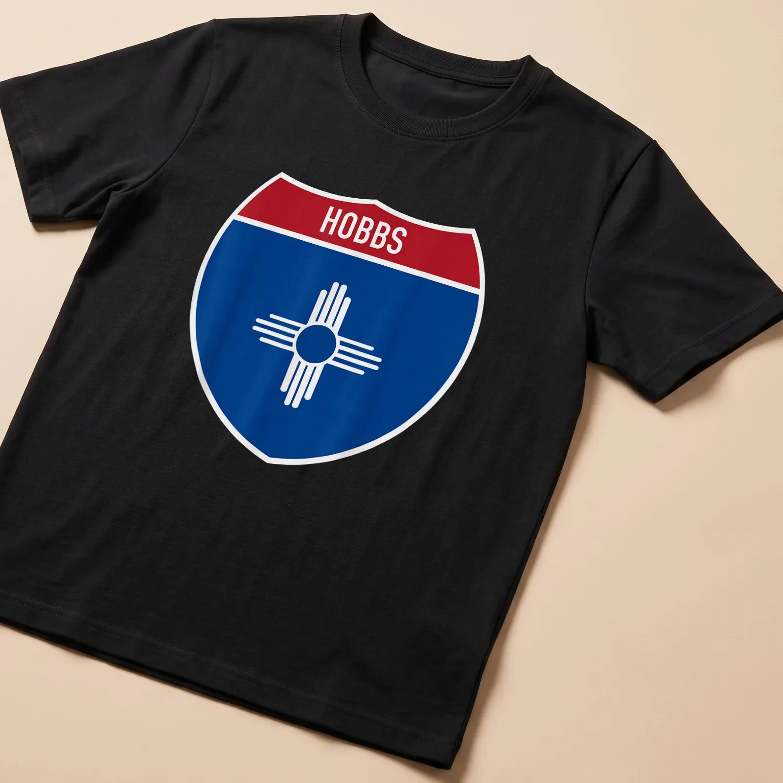 Hobbs New Mexico highway sign t-shirt in shield design with blue, red, and white colors — printed on a unisex t-shirt