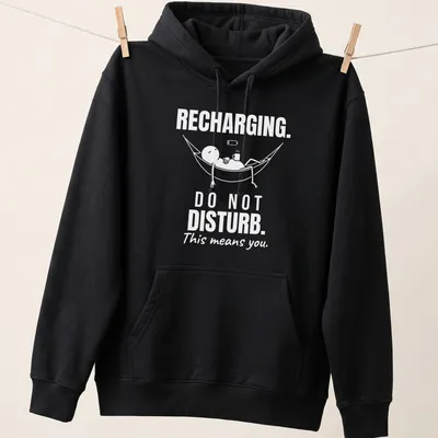 Funny typography tee showing a person relaxing in a hammock with a do not disturb message. — printed on a unisex hoodie