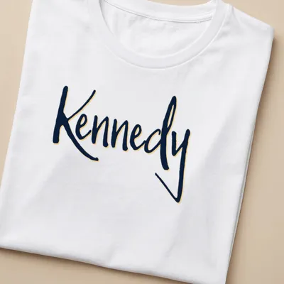 Elegant script shirt featuring the name Kennedy in gold on navy blue — printed on a women's shirt
